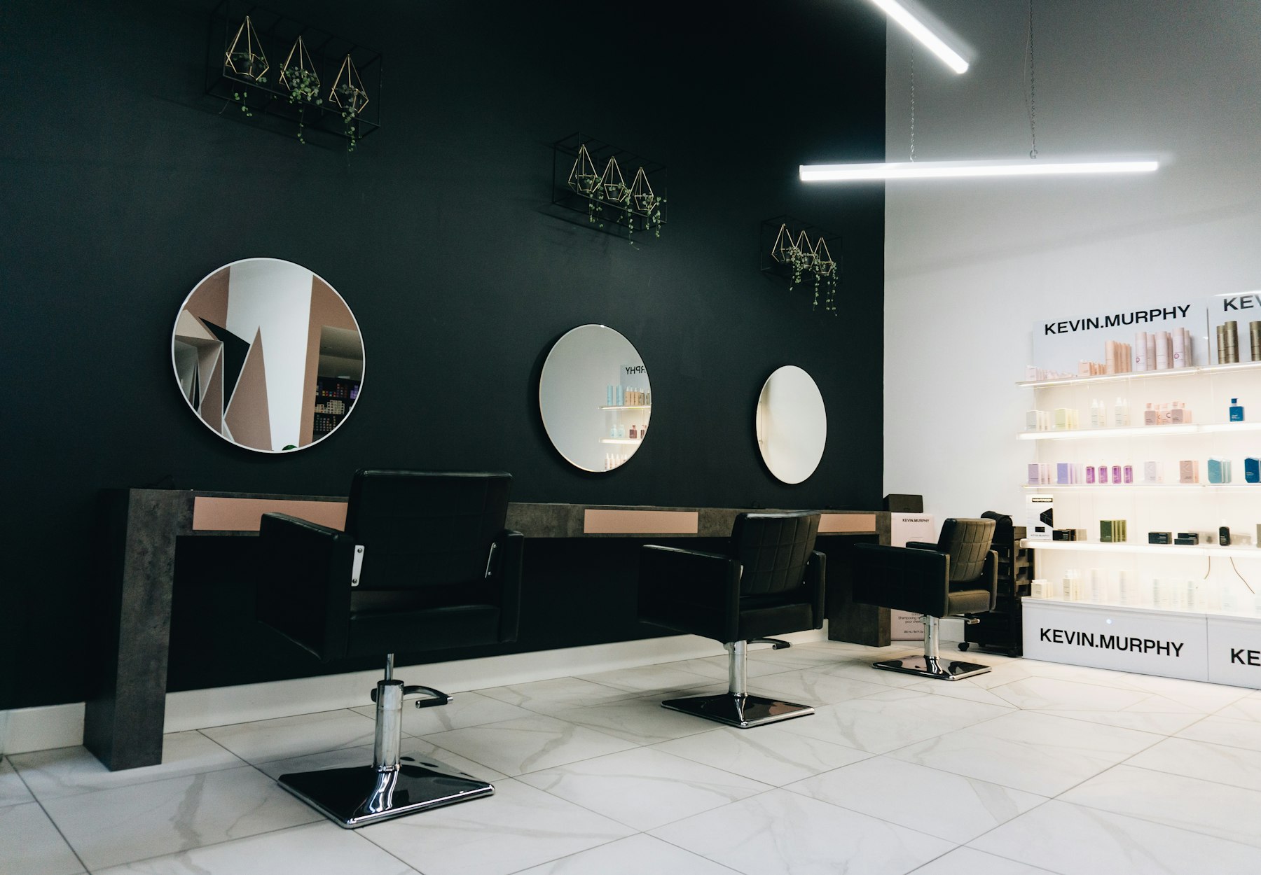 Salon chairs facing round mirrors