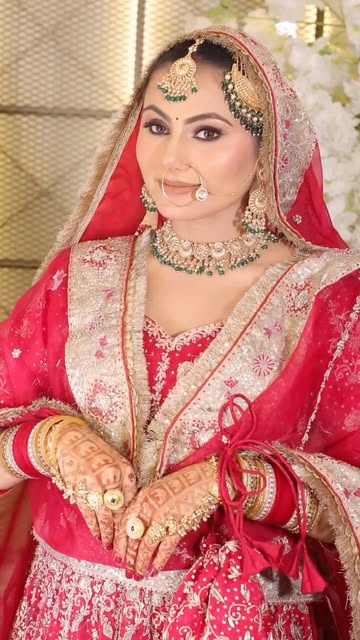 Bride in red lehenga with bridal makeup by Samriz