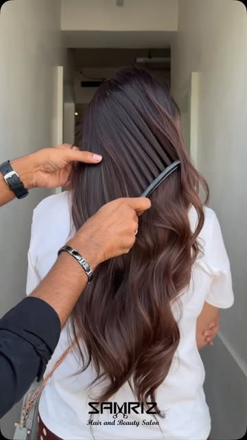 Chocolate brunette waves being combed through